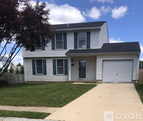 A two-story house with a garage on the right side.