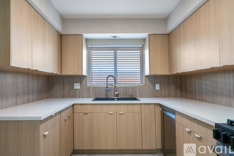A kitchen with wooden cabinets and a white countertop.