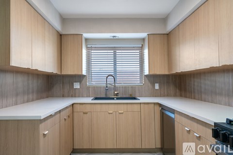 A kitchen with wooden cabinets and a white countertop.