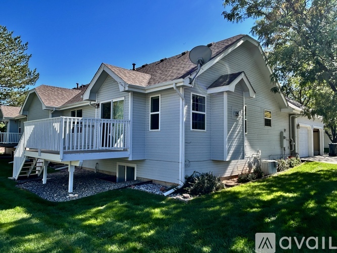 A house with a white exterior and a balcony is for sale.