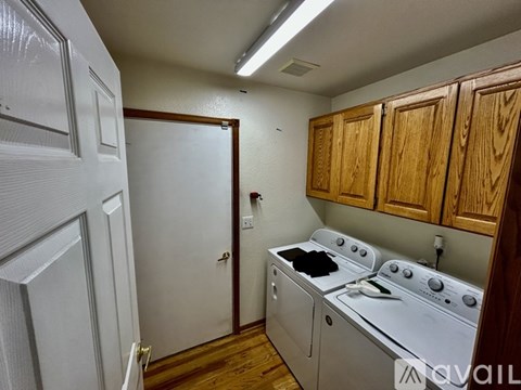A small kitchen with a white oven and wooden cabinets.