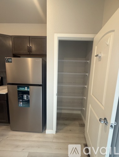 A stainless steel refrigerator with a water and ice maker in a kitchen.