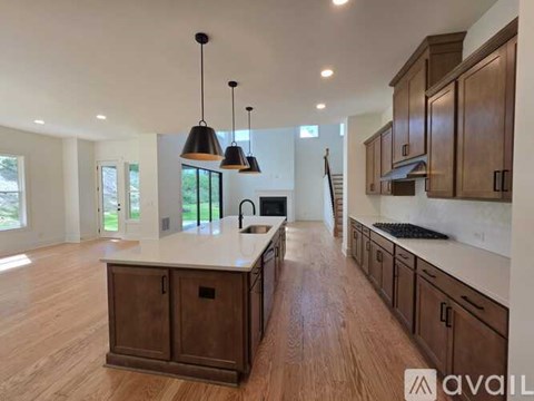A modern kitchen with wooden cabinets and a central island.
