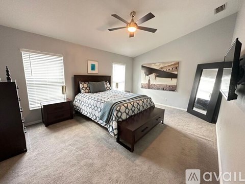 A bedroom with a bed, dresser, and mirror.