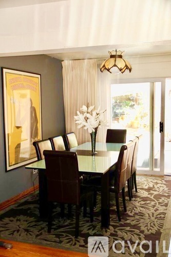A dining room with a table set for six.