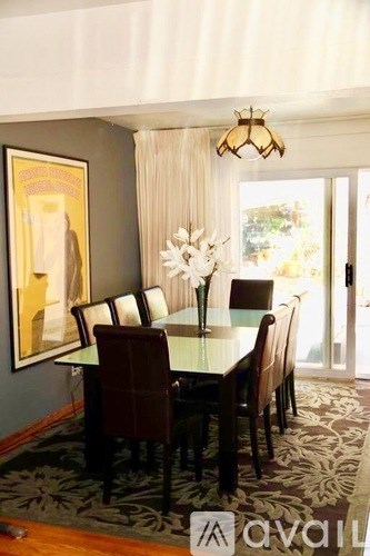 A dining room with a table set for six.