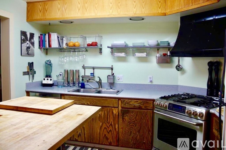 A kitchen with wooden cabinets and a stove top oven.