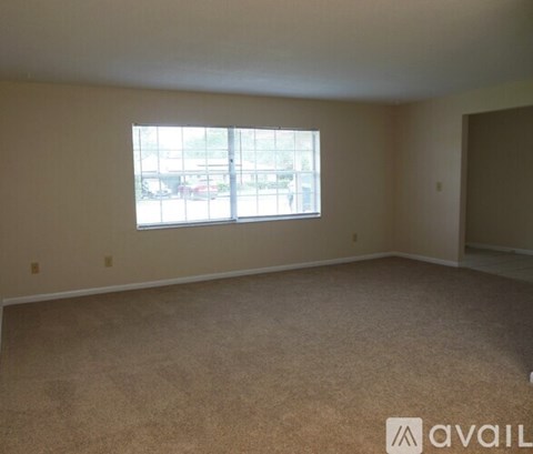 Empty room with a window and car view outside.