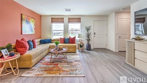 A living room with a yellow sofa, a small table, and a rug.