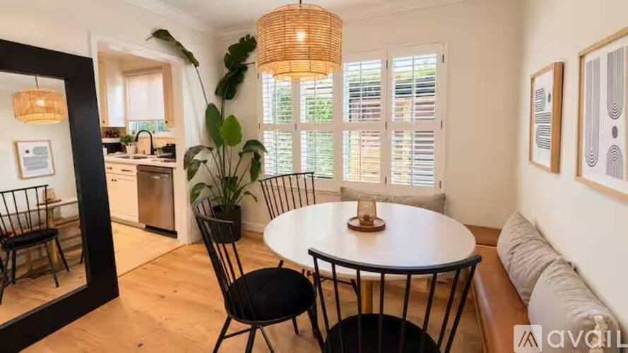 A dining area with a round table and chairs.