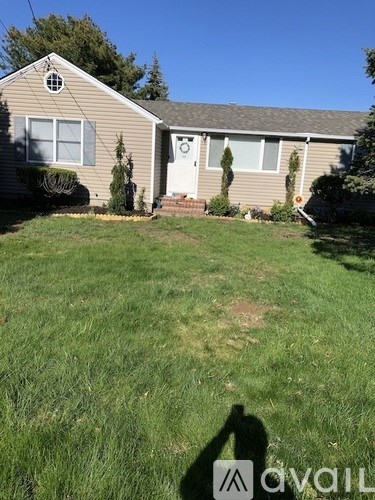A house with a lawn in front of it.