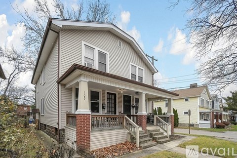 A house with a porch and a front yard.