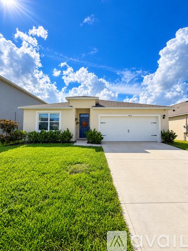 A house with a blue sky and clouds in the background.