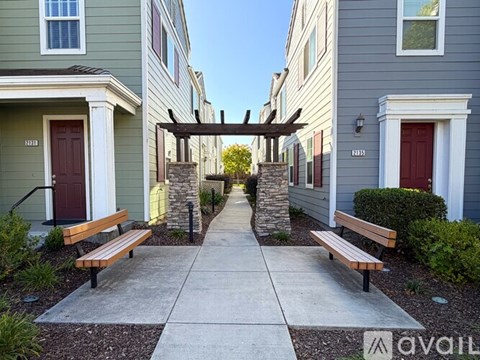 A row of houses with a walkway between them.