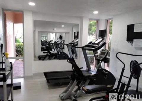 A gym with treadmills and exercise bikes.