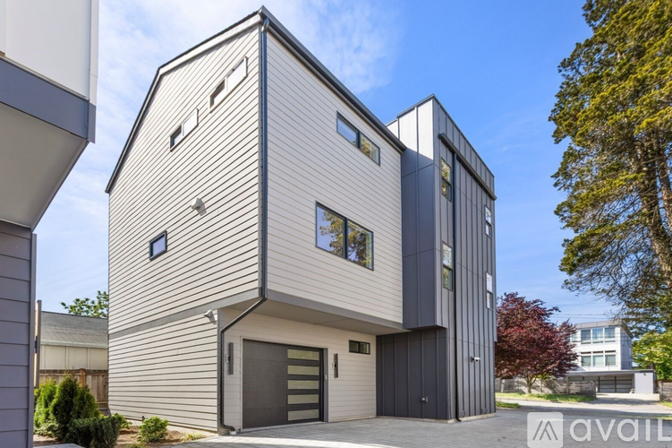 A modern house with a combination of grey and black exterior.