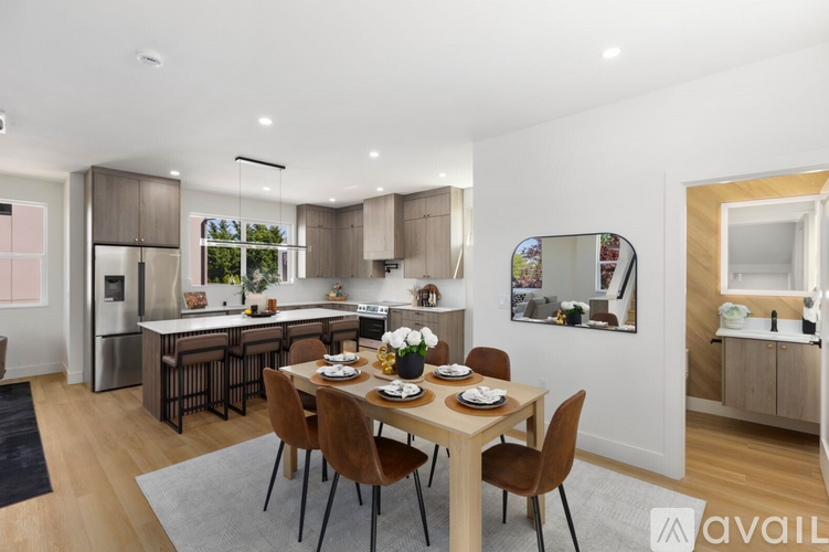 A modern kitchen with a dining table set for four.