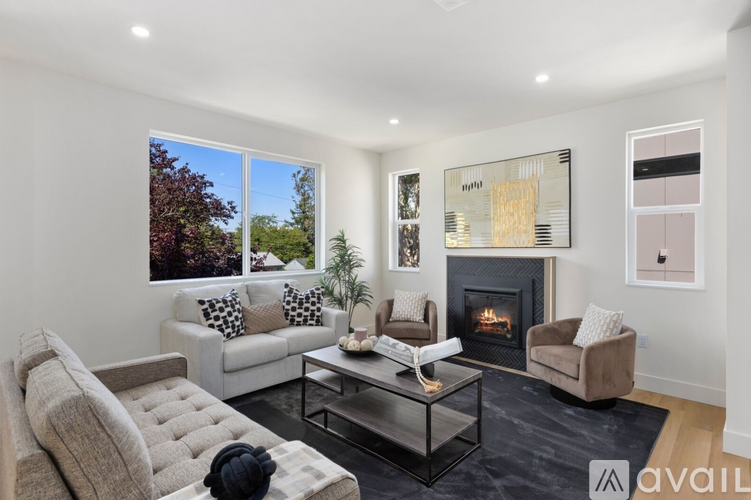A modern living room with a fireplace and a large window.