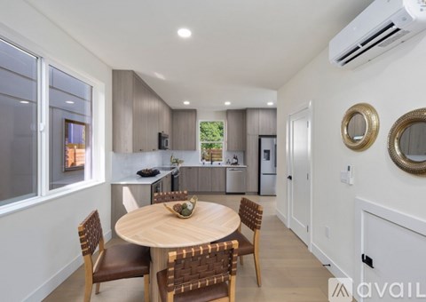 A modern kitchen with a dining table and chairs.