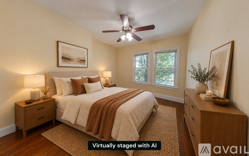 A bedroom with a bed, nightstands, and a ceiling fan.