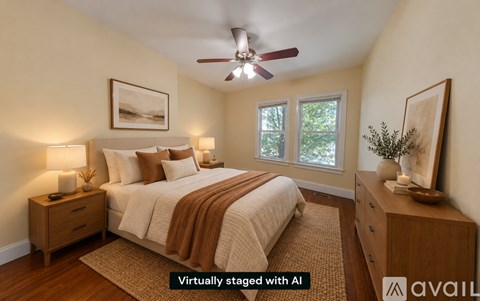 A bedroom with a bed, nightstands, and a ceiling fan.
