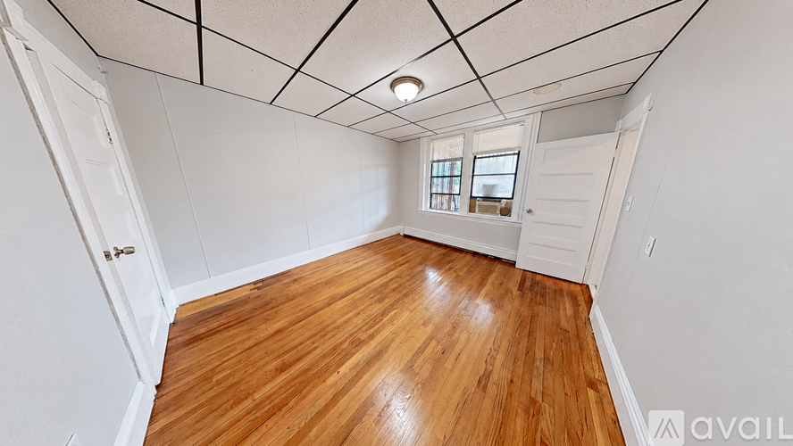 A room with wooden floors and white walls.