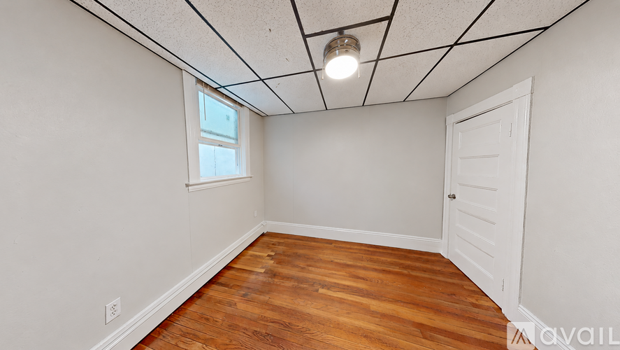A room with wooden floors and a white door.