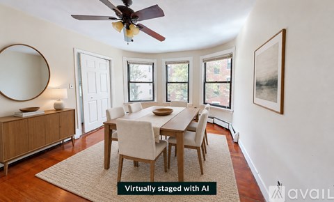 A dining room with a table set for four.