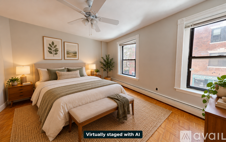 A bedroom with a bed, a nightstand, a window, and a plant.