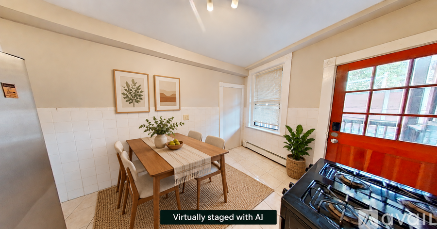 A dining room with a table set for two and a plant on the table.