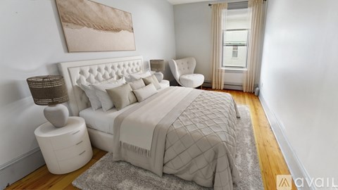A bedroom with a large bed and a painting on the wall.