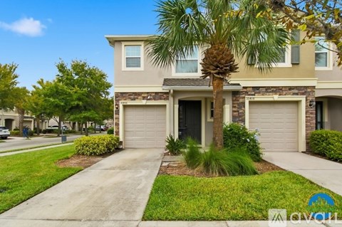 A house with a palm tree in front of it.