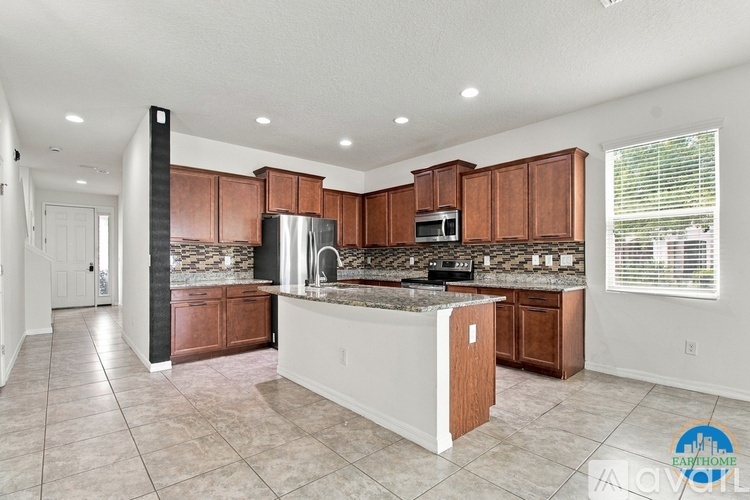 A kitchen with brown cabinets and a white island.