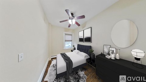 A bedroom with a bed, a dresser, and a ceiling fan.