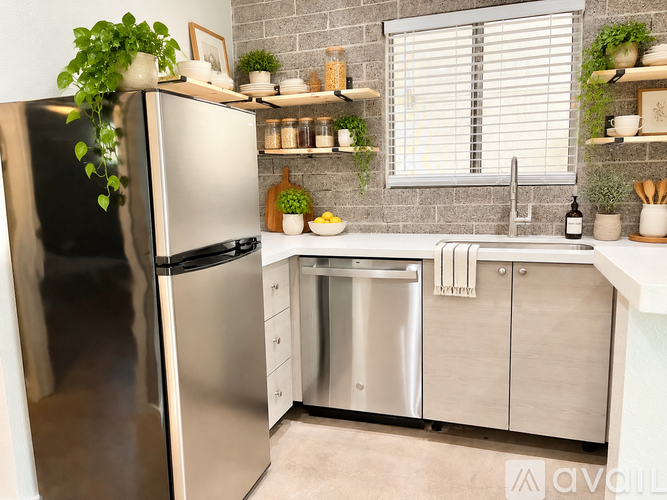 A kitchen with a stainless steel refrigerator and a dishwasher.