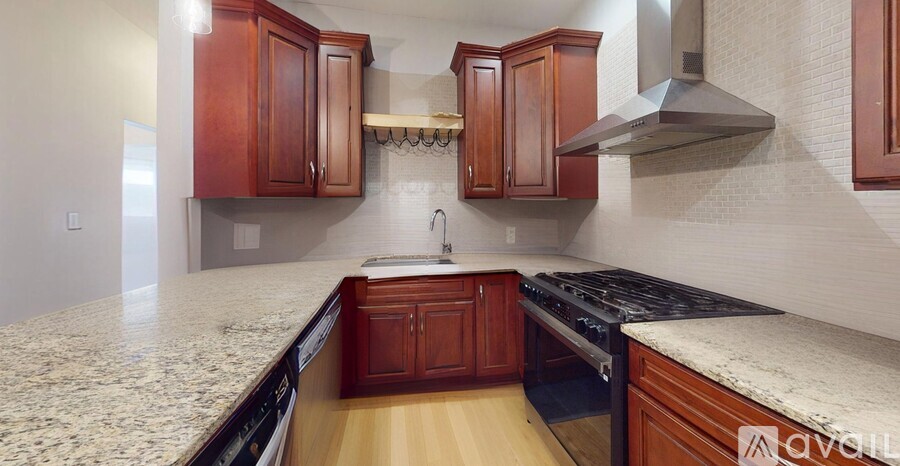 A kitchen with wooden cabinets and a granite countertop.
