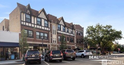 A street view of a building with cars parked in front and the words "BEALPROPERTIES AVAILABLE" on the image.