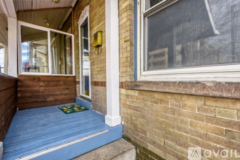 A house entrance with a blue mat on the floor.