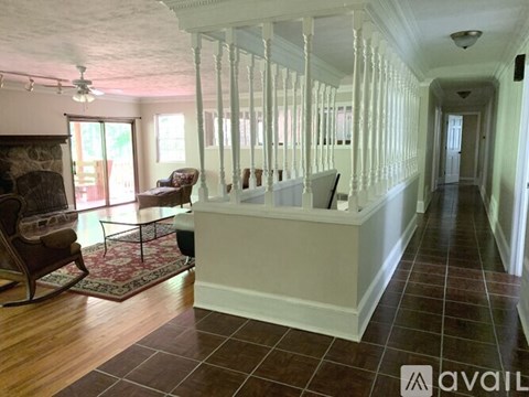 A living room with a rocking chair and a fireplace.