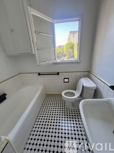 A bathroom with a black and white checkered floor.