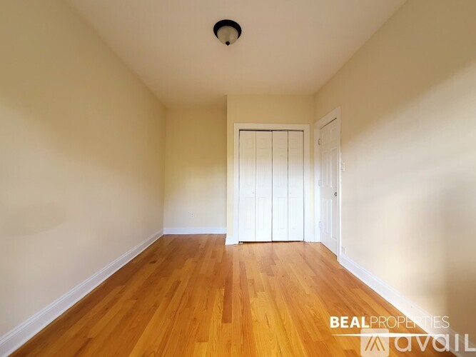 A room with wooden floors and a white door.