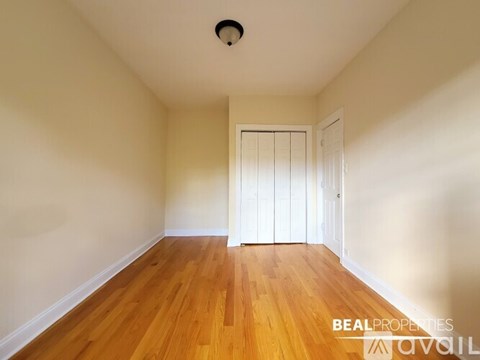 A room with wooden floors and a white door.