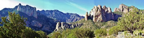 A mountain range with trees in the foreground.