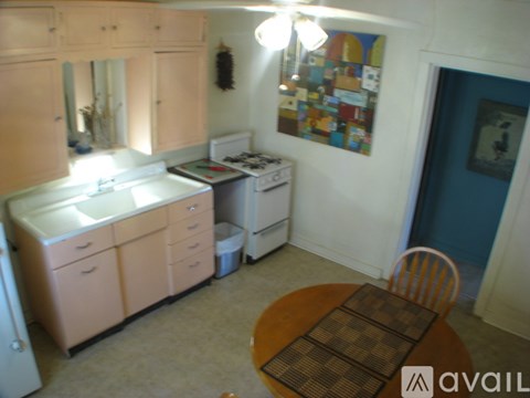 A kitchen with a table and chairs.
