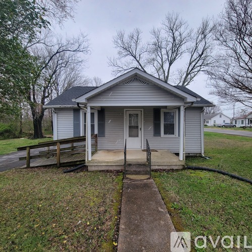 A small house with a porch and a covered entrance.