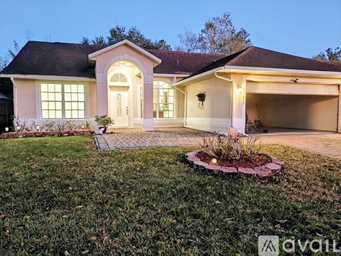 A house with a front yard and a driveway.