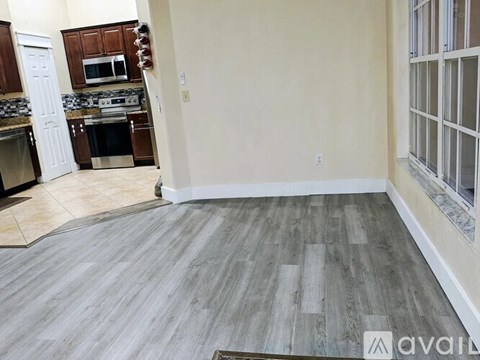 A kitchen with a white oven and a wooden cabinet.