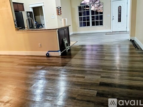 A room with wooden flooring and a white door.