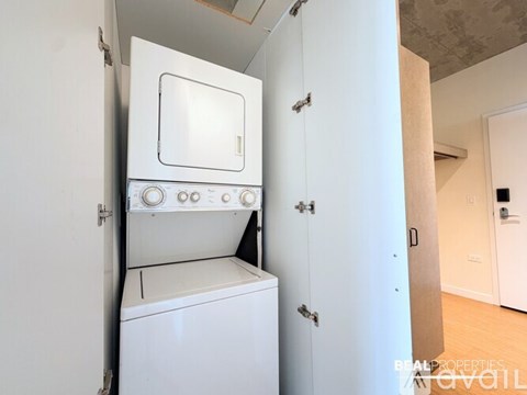 A white oven and dishwasher are built into a kitchen cabinet.