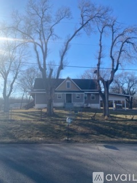 A house with a tree in front of it.